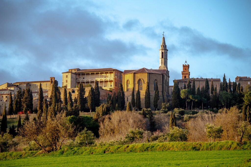 Pienza skyline and cathedral seen from countryside, Val d’Orcia Tuscany